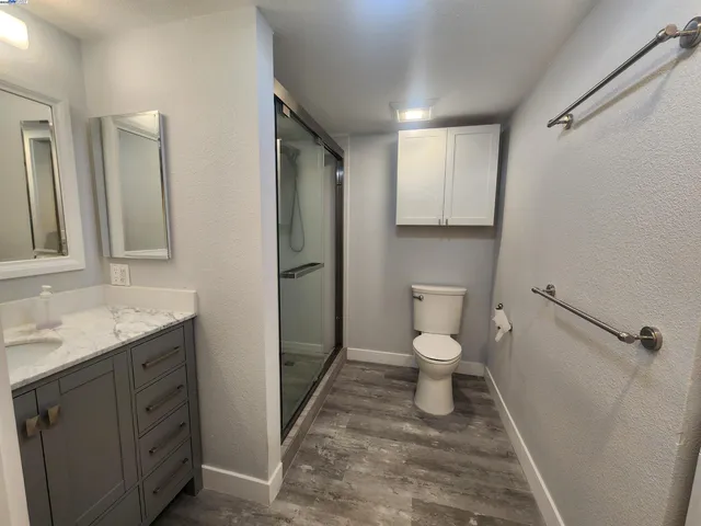 a bathroom with a toilet sink and shower