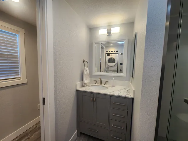a bathroom with a granite countertop sink double vanity and a mirror
