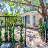 a view of a house with a tree in the yard