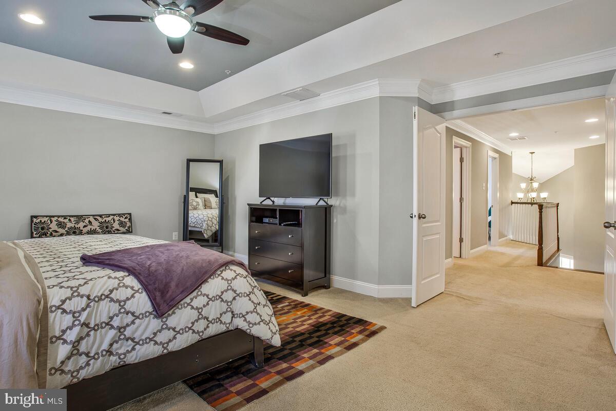 802 Phyllis Street Odenton, MD 21113 - Photo 23 of 35 a spacious bedroom with a bed and a flat screen tv