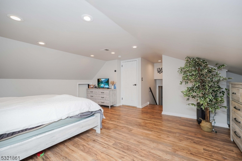 13 Bartle Road Somerset, NJ 08873 - Photo 17 of 24 a spacious bedroom with a bed and a potted plant