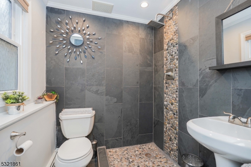 13 Bartle Road Somerset, NJ 08873 - Photo 18 of 24 a bathroom with a toilet sink and shower curtain