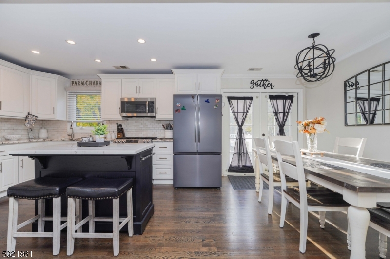 13 Bartle Road Somerset, NJ 08873 - Photo 6 of 24 a kitchen with a table chairs a sink and a refrigerator