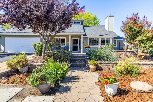 a front view of a house with a yard and fountain