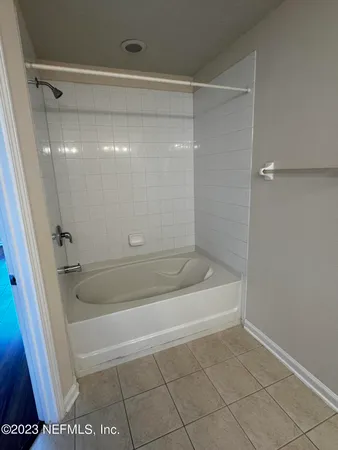 a bathroom with a shower and a bath tub