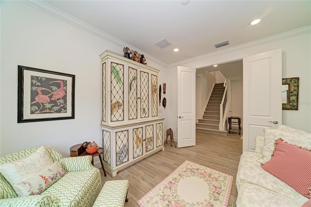 16341 Hidden Oak Loop Lakewood Ranch, FL 34211 - Photo 36 of 76 a living room with furniture and wooden floor