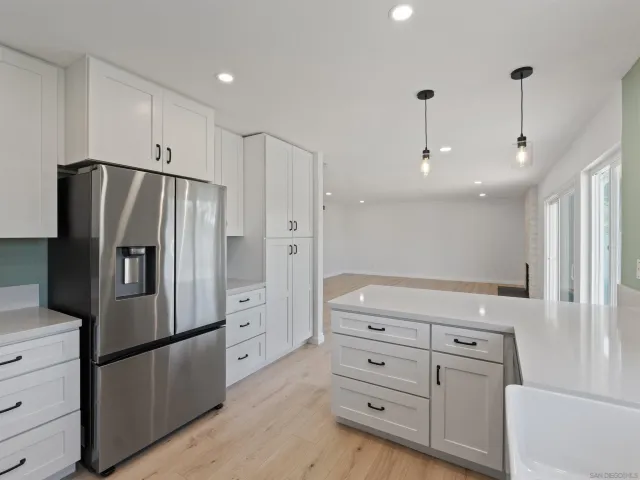 a kitchen with stainless steel appliances a refrigerator and a stove