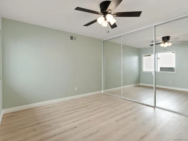 an empty room with fan and a ceiling fan
