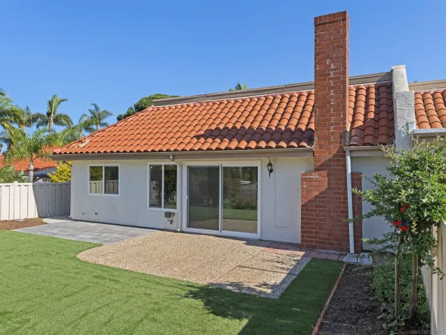a front view of a house with a garden and yard
