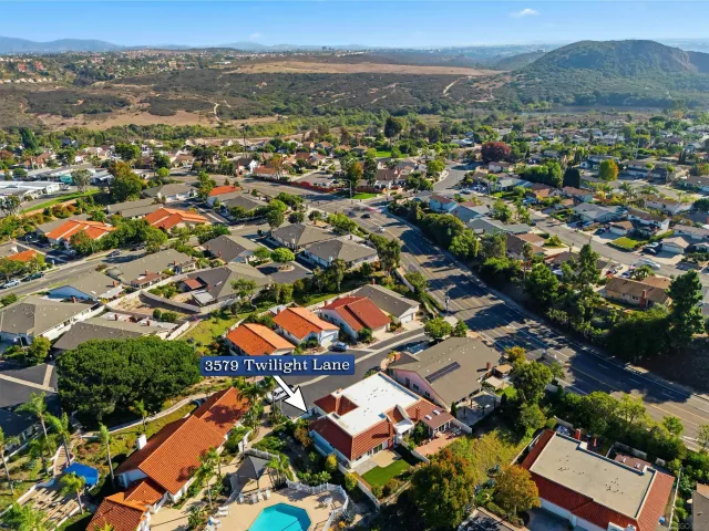 an aerial view of residential building with green space
