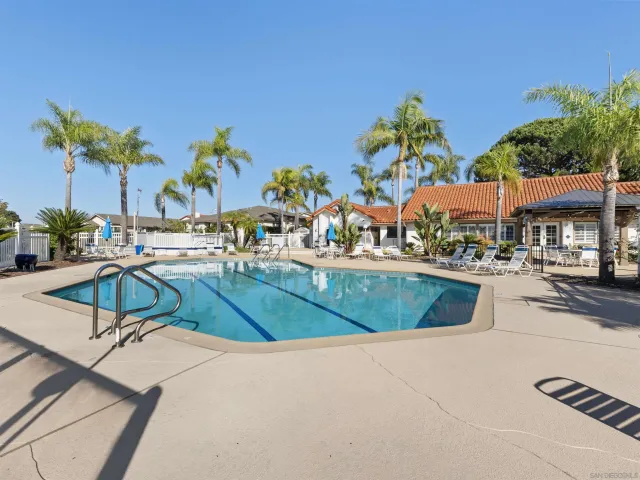 a view of a swimming pool with outdoor seating