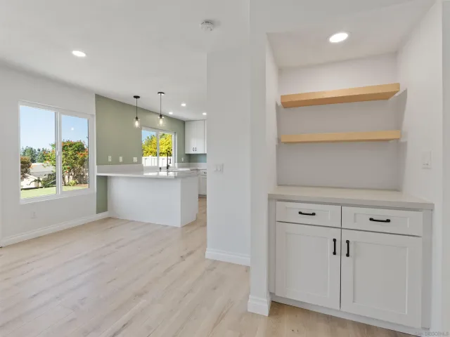 a view of a kitchen with furniture and wooden floor