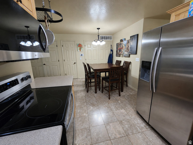 2525 West 450 South, Unit 8 Springville, UT 84663 - Photo 4 of 22 Kitchen featuring stainless steel appliances, light wood-finish cabinetry, neutral countertops, and tile flooring