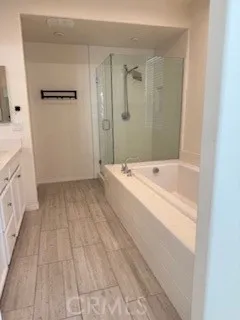 a view of bathroom with bathtub wooden floor and window