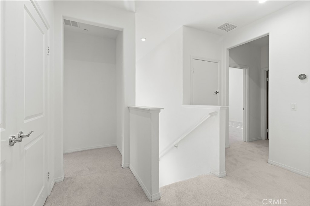 166 Natal Road Rancho Mission Viejo, CA 92694 - Photo 14 of 45 a view of a hallway with white walls