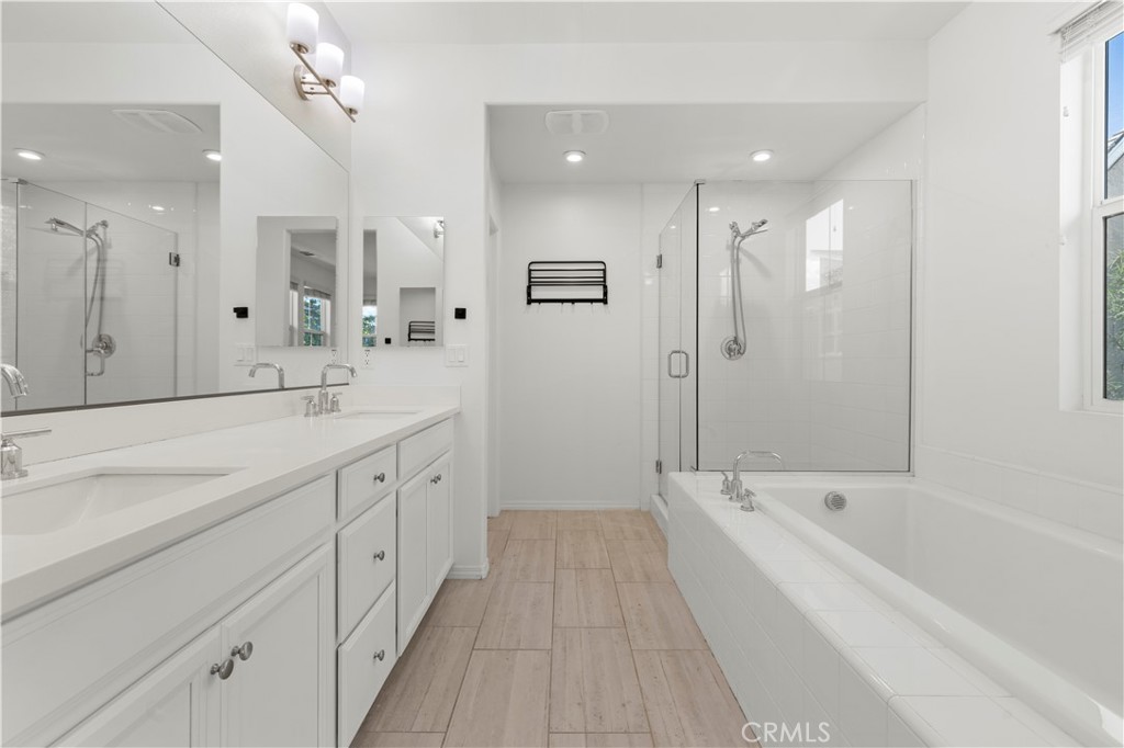 166 Natal Road Rancho Mission Viejo, CA 92694 - Photo 21 of 45 a spacious bathroom with a large tub shower and double vanity
