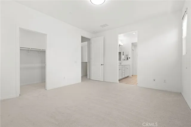 a large kitchen with stainless steel appliances granite countertop a large window a wooden floor and a sink