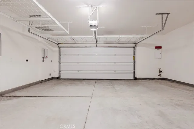 a kitchen with stainless steel appliances granite countertop a refrigerator a stove a sink dishwasher and a oven with wooden floor