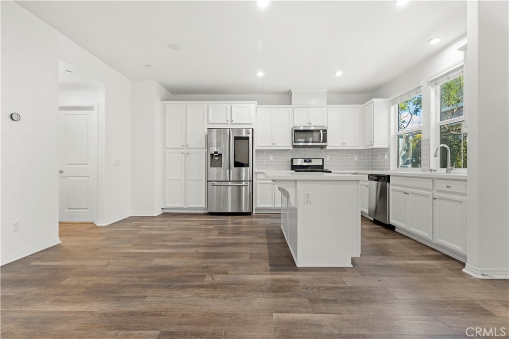 166 Natal Road Rancho Mission Viejo, CA 92694 - Photo 29 of 45 a view of kitchen with wooden floor and electronic appliances