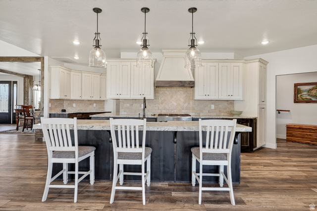 3311 West Allard Summit, UT 84772 - Photo 26 of 97 Kitchen featuring a large island with seating, pendant lighting, white upper cabinetry, and a herringbone tile backsplash