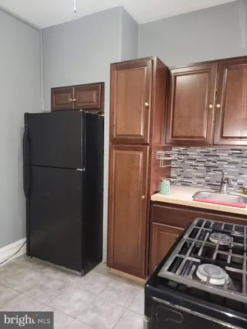 a kitchen with metallic refrigerator freezer and a sink