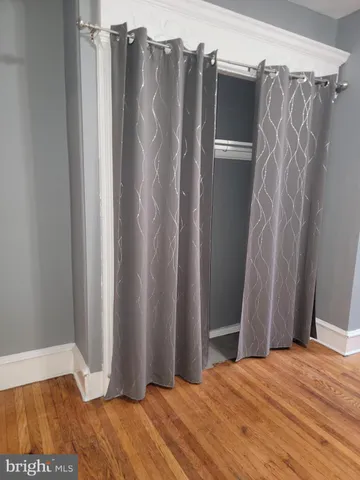a view of closet with wooden floor