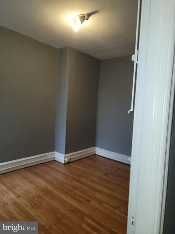 an empty room with wooden floor