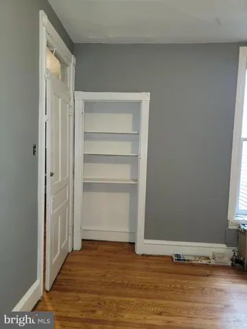 a view of a room with wooden floor