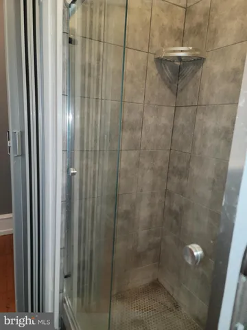 a bathroom with a glass shower door