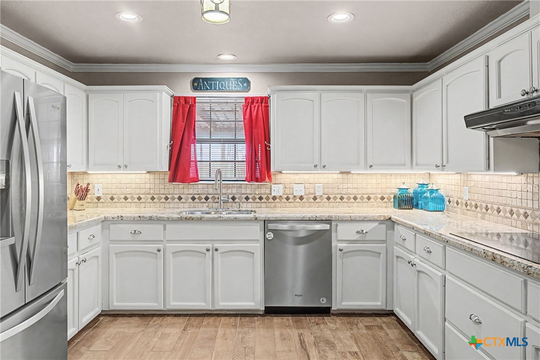 1601 Sunset Circle Cameron, TX 76520 - Photo 18 of 40 a kitchen with granite countertop a white sink and cabinets