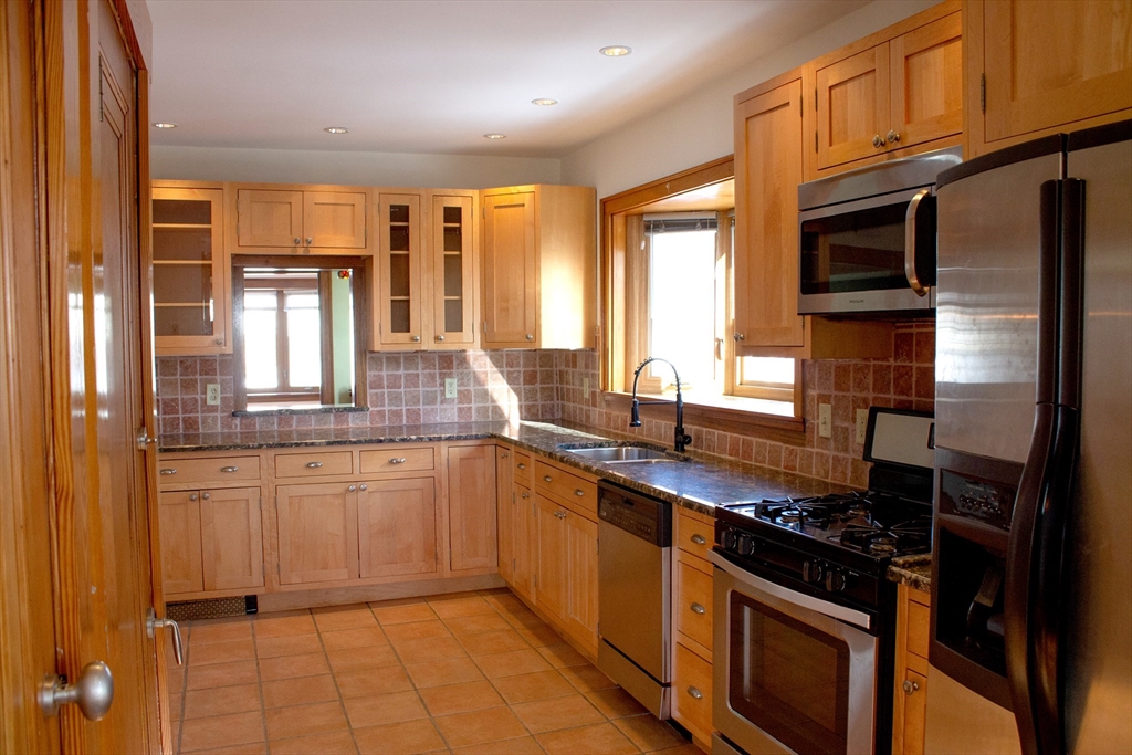 2-4 Sunset Hill Road Boston, MA 02132 - Photo 13 of 34 a kitchen with stainless steel appliances a stove sink and cabinets