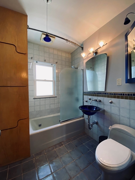 2-4 Sunset Hill Road Boston, MA 02132 - Photo 23 of 34 a bathroom with a granite countertop toilet sink and mirror