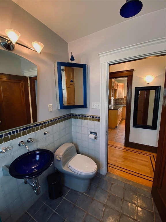 2-4 Sunset Hill Road Boston, MA 02132 - Photo 24 of 34 a bathroom with a toilet sink and mirror