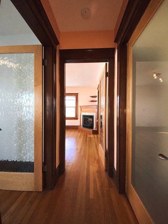 2-4 Sunset Hill Road Boston, MA 02132 - Photo 4 of 34 a view of a hallway with wooden floor and closet