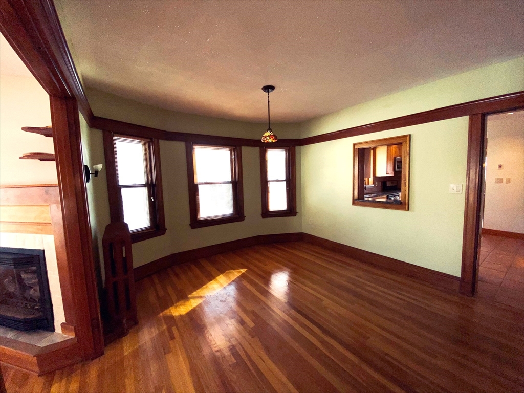 2-4 Sunset Hill Road Boston, MA 02132 - Photo 8 of 34 a view of an empty room with wooden floor and a window