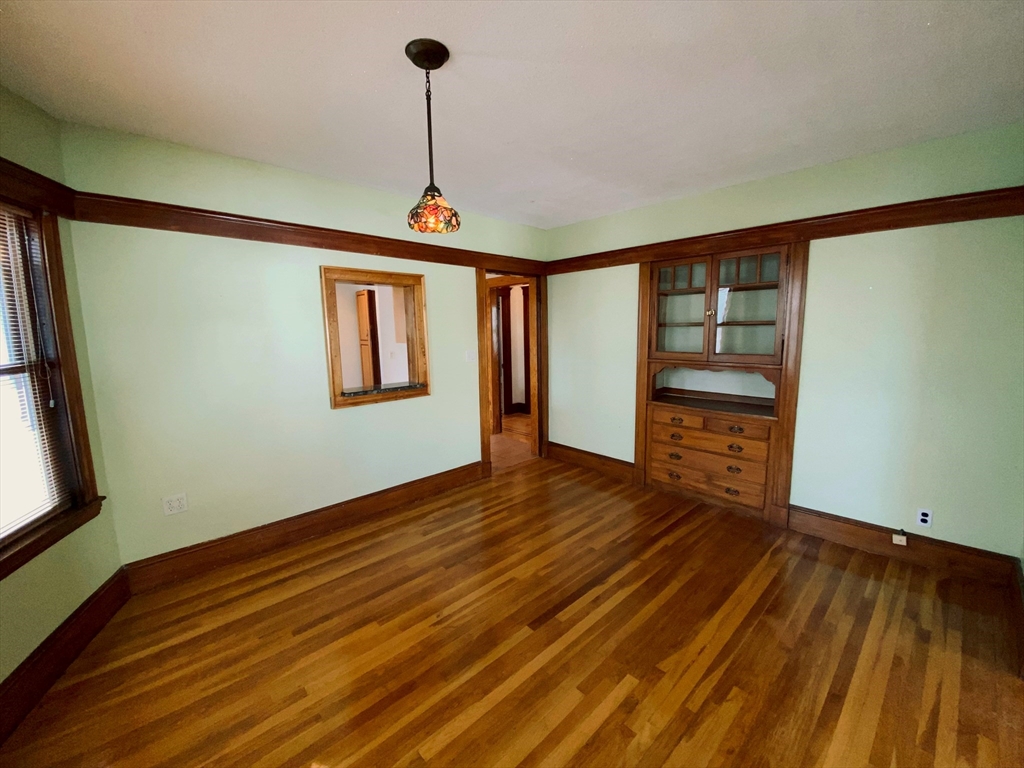 2-4 Sunset Hill Road Boston, MA 02132 - Photo 9 of 34 a view of empty room with wooden floor and fan