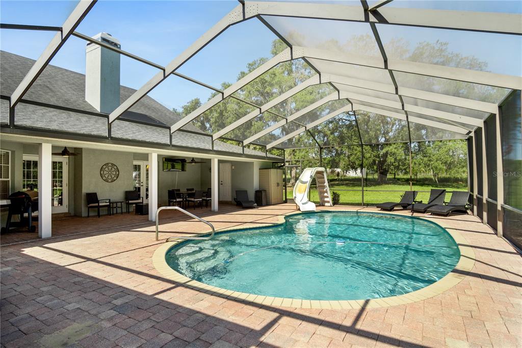9045 Lake Hatchineha Road Kissimmee, FL 34759 - Photo 12 of 47 a view of a swimming pool with a patio