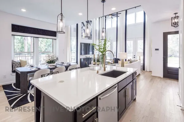 a kitchen with stainless steel appliances a sink a stove and a refrigerator