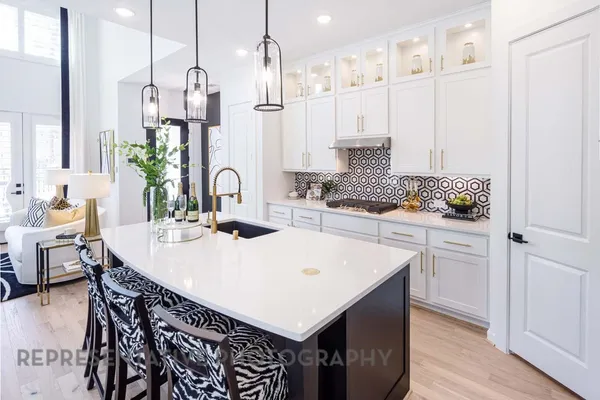 a kitchen with kitchen island a sink table and chairs