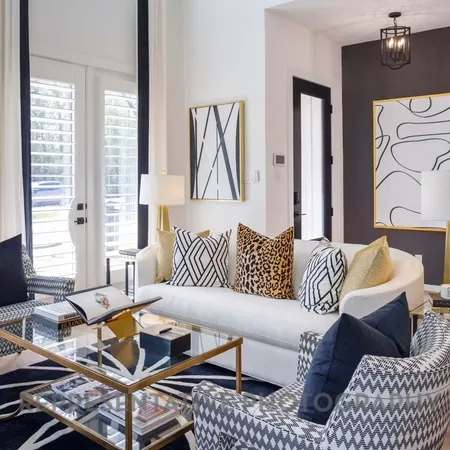 a living room with furniture and large windows