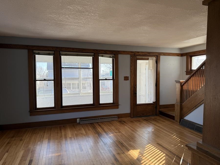 816 West Pleasant Street Freeport, IL 61032 - Photo 13 of 42 an empty room with wooden floor and windows