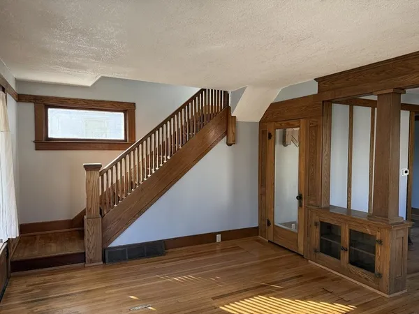 a view of entryway and hall with wooden floor