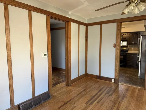 a view of hallway with wooden floor