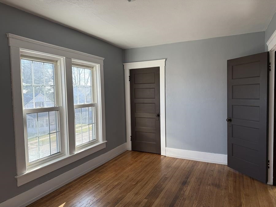 816 West Pleasant Street Freeport, IL 61032 - Photo 20 of 42 wooden floor in an empty room with a window