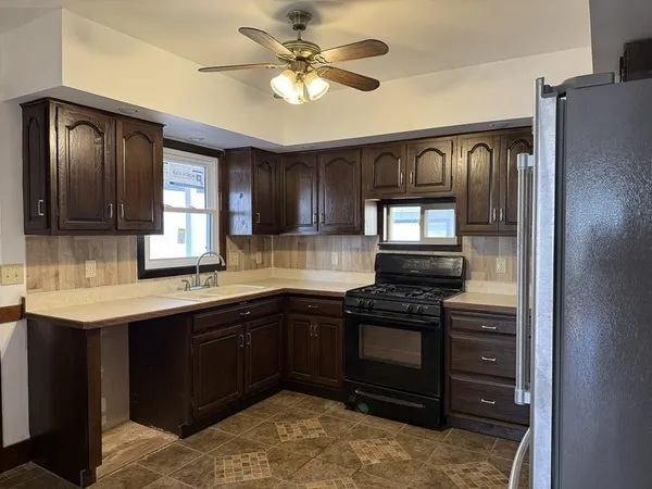 a kitchen with stainless steel appliances granite countertop a stove and a refrigerator