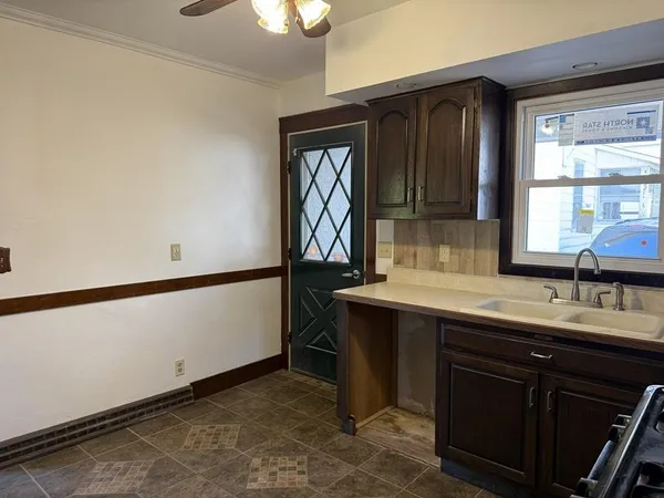 a kitchen with a sink and a refrigerator