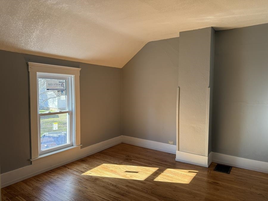 816 West Pleasant Street Freeport, IL 61032 - Photo 27 of 42 an empty room with wooden floor and windows