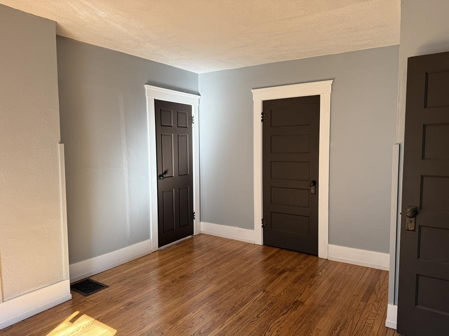 816 West Pleasant Street Freeport, IL 61032 - Photo 29 of 42 a view of an empty room with wooden floor and closet