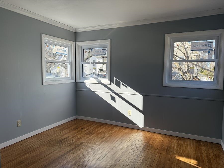 816 West Pleasant Street Freeport, IL 61032 - Photo 31 of 42 a view of an empty room with wooden floor and a window