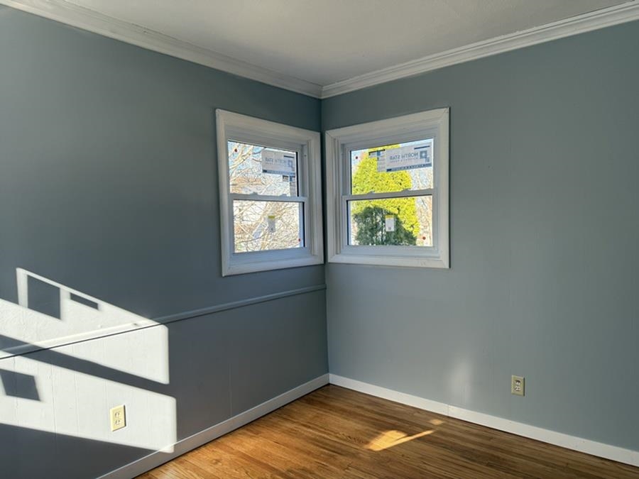 816 West Pleasant Street Freeport, IL 61032 - Photo 32 of 42 a view of an empty room with wooden floor and a window